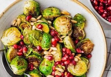 Roasted Brussels sprouts with pomegranate seeds and pine nuts.