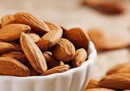 A bowl filled with whole almonds.